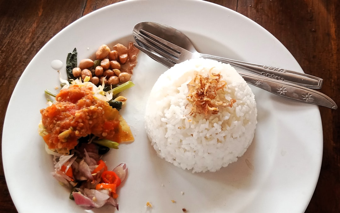 a white plate topped with rice and beans